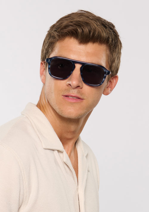 ZANDER | Ripple Handcrafted, luxury dark blue tortoise acetate large rectangular aviator KREWE sunglasses mens model | Model: Ben